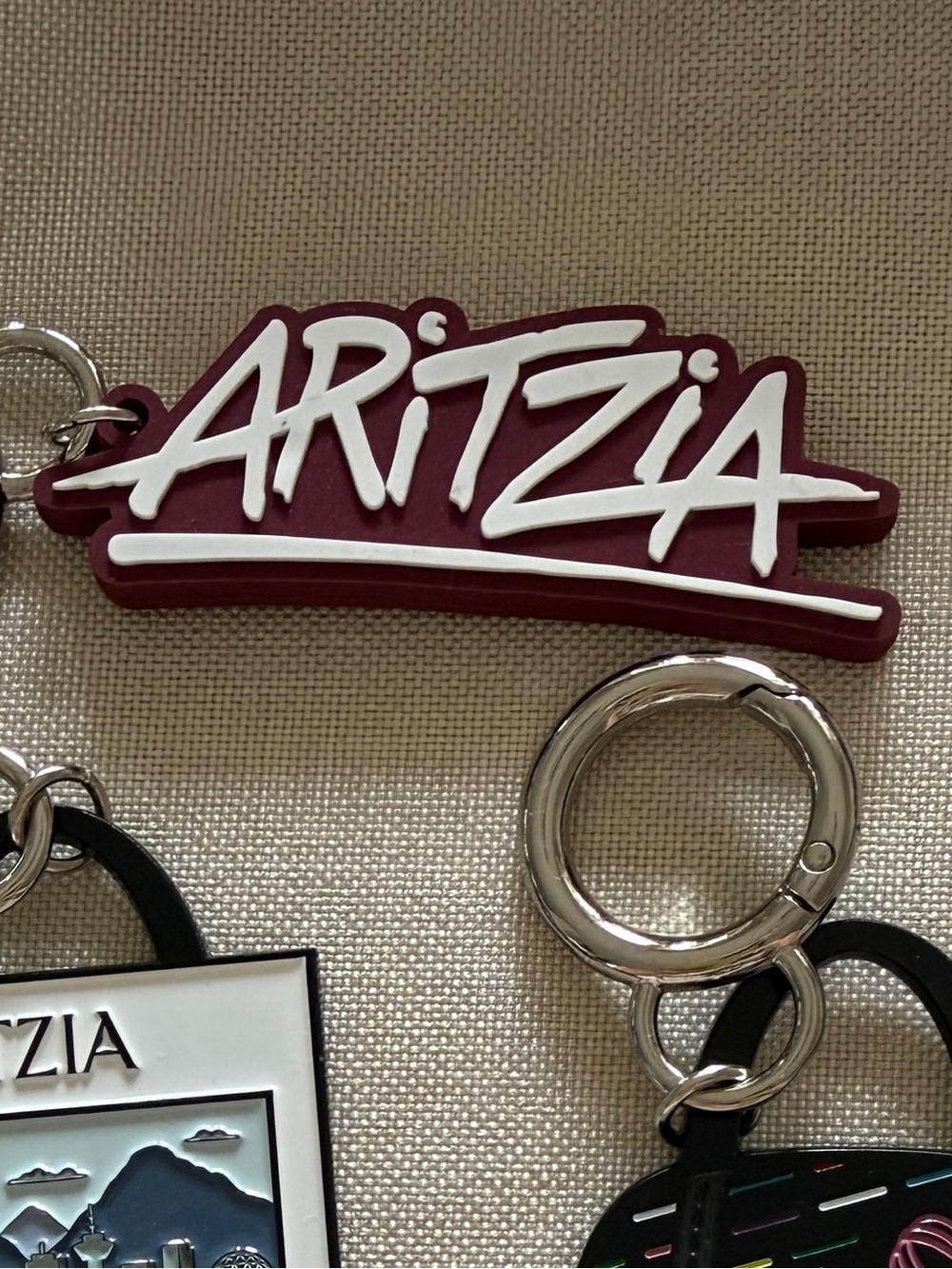 Aritzia Maroon and White Logo Key Charm